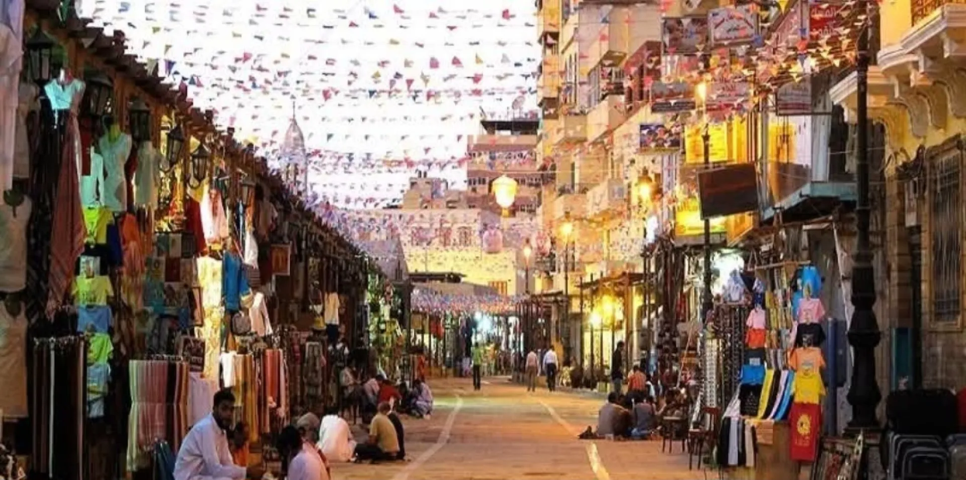 Private guided tour exploring colorful spice stalls in Aswan Souq at night
